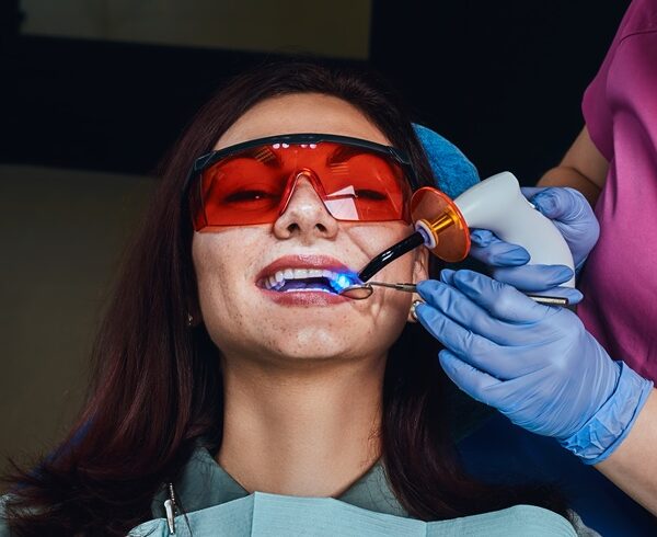 Female dentist treating a patient. A young woman sitting in the dentist's chair.