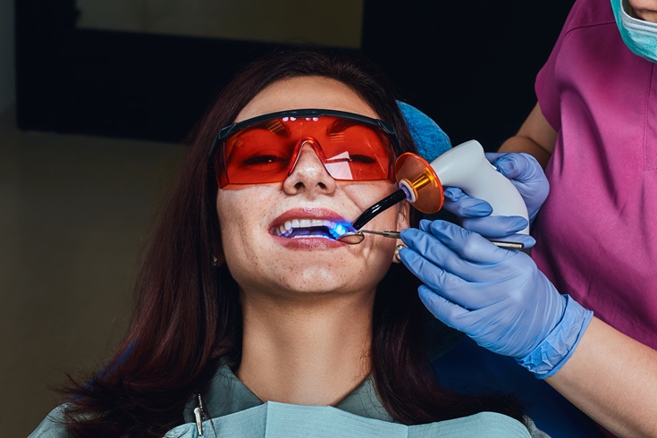 Female dentist treating a patient. A young woman sitting in the dentist's chair.